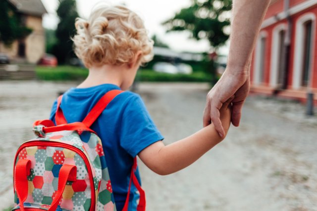 Child going to school with his parents
