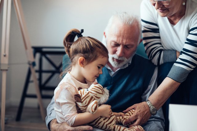 Small girl playing with her grandparents